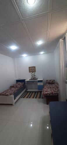 a room with two beds in a room at bikla f3 2nd floor in Khenchela