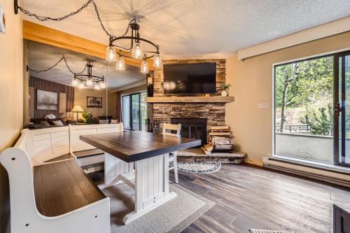 a kitchen with a table and a fireplace at Beaver Run, King Studio, Ground Floor, Dog Friendly in Breckenridge