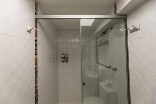 a shower with a glass door in a bathroom at Quechua Hotel Cusco in Cusco