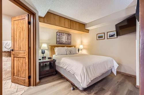 a bedroom with a large bed and a television at Beaver Run Resort Studio 4033 in Breckenridge
