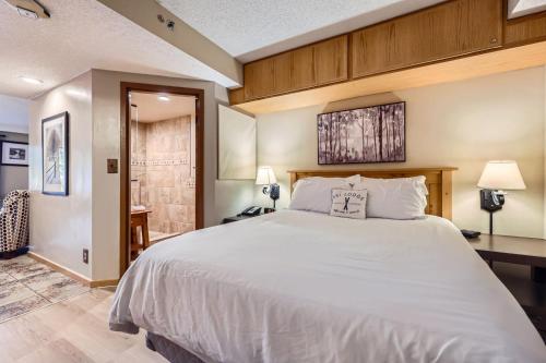 a bedroom with a large bed and a desk at Beaver Run Resort Studio 4033 in Breckenridge