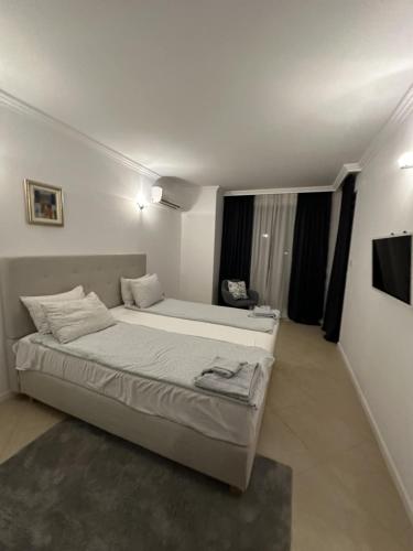a bedroom with a bed and a television in it at Oasis Beach Club - "Valencia'' apartment in Lozenets