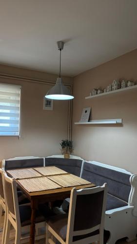 a dining room with a table and a blue couch at Charlie&Blueberries in Belgrade