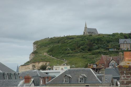 a hill with a church on top of it at Nid Élégant - Vue Chapelle et Mer in Étretat