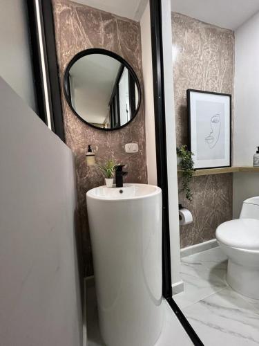 a bathroom with a white sink and a mirror at Salento Boutique Mini House, Private, Complete in Salento
