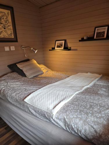 a bedroom with a large bed with a lamp at Sólvellir in Selfoss