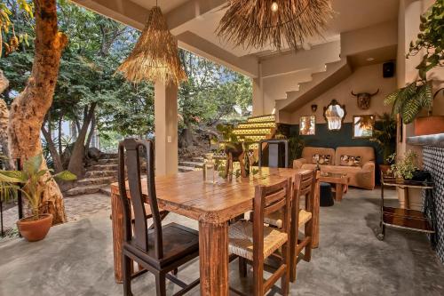 a dining room with a wooden table and chairs at Private 5-Bedroom Compound with Pool Tepoztlán Retreat in Tepoztlán