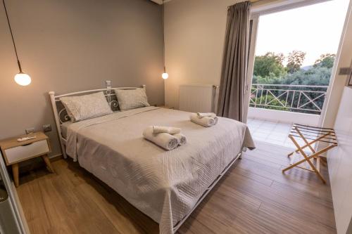 a bedroom with a bed with towels on it at My Nafpaktos Resort in Nafpaktos