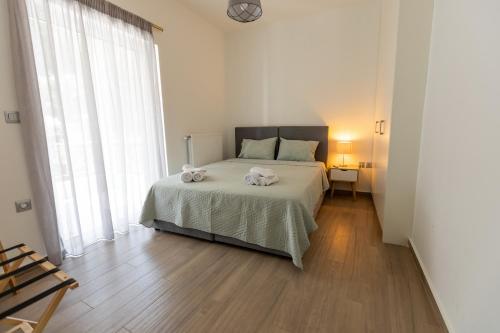 a bedroom with a bed with two towels on it at My Nafpaktos Resort in Nafpaktos