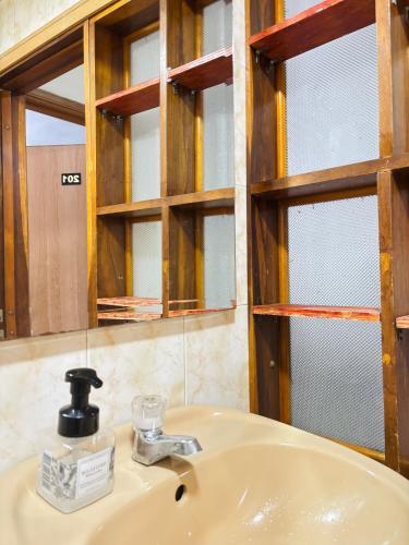 a bathroom with a sink and a mirror at Room Airport in Bogotá