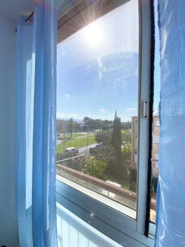 a window with a view of a street at Premium Haim apt in Haifa