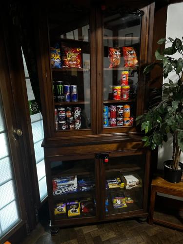 a wooden cabinet with food in it at Barons Court Hotel in Wolverhampton