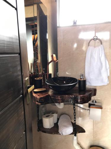 a bathroom with a black sink and a mirror at Rancho dos lagos in Campo Alegre