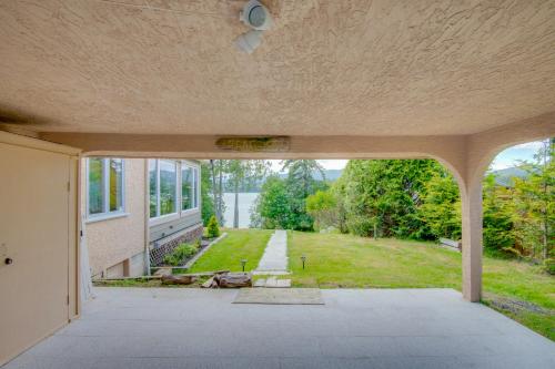 an empty house with a view of a yard at Oceanfront Getaway in Sooke
