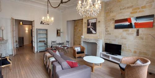 a living room with a couch and a fireplace at Burdigala Homes - Appart Duffour Dubergier in Bordeaux