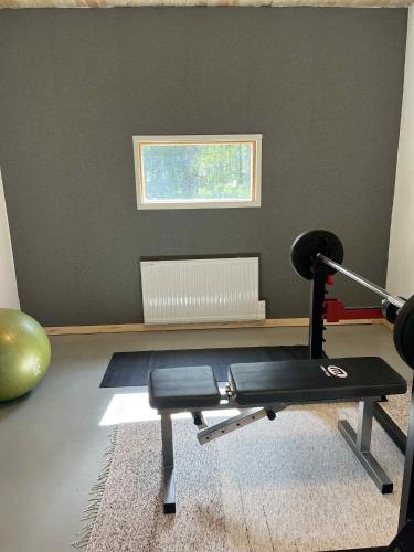 a room with a gym with a bench and a window at Villa Kuninkaankivi in Kalajoki
