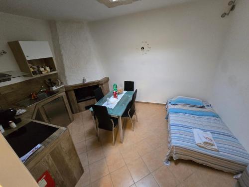 a room with a bed and a table with chairs at MERCADANTE - Luxury Holiday House in Cassano delle Murge