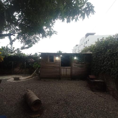 a yard with a wooden gate and a fence at Paraíso Hortensia Honeymoon Suite in Santiago de los Caballeros