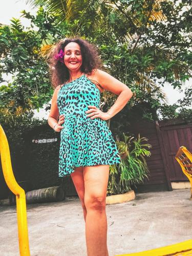 a woman in a dress standing on a yellow rail at Paraíso Hortensia Honeymoon Suite in Santiago de los Caballeros