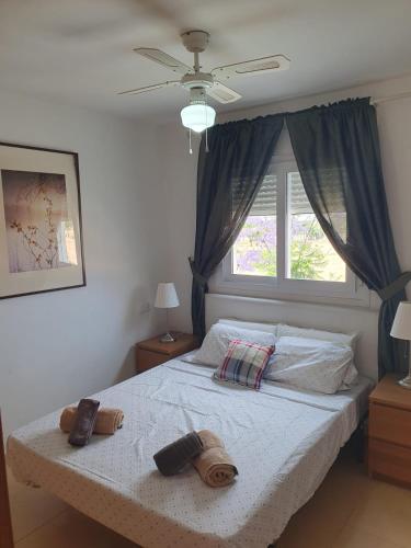 a bedroom with a large bed with a window at Naranjos Condado in Alhama de Murcia
