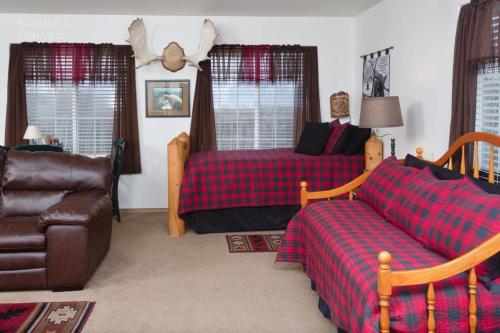 a living room with two beds and a couch at Alaska's Harvest Bed and Breakfast and Luxury Log Cabin in Palmer