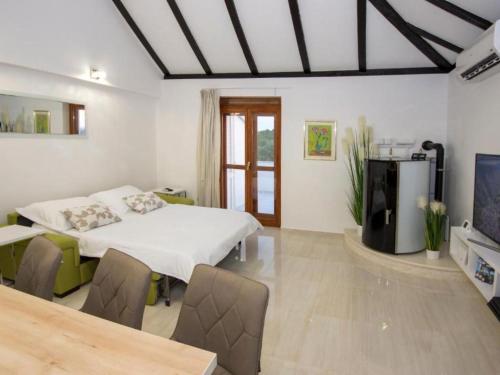 a bedroom with a bed and a tv in it at Villa Gabriel - Three Bedroom Villa with Outdoor Pool in Drniš