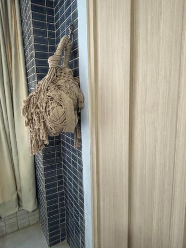 a towel hanging on a blue tiled wall at Ora Beach 108 Porto de Galinhas in Porto De Galinhas