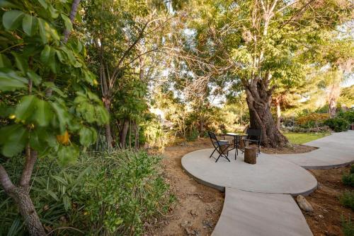 a walkway with a table and chairs in a park at Quiet and Central 1bed1bath House, Nature Retreat in Rosemead