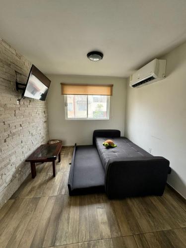 a room with a bed and a table in it at Condominio Costa Sol in Boca del Río