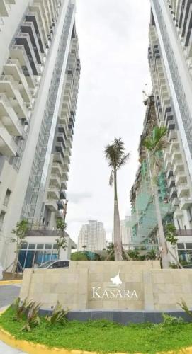 a view of two tall buildings with palm trees at House of Lilith at Kasara in Manila