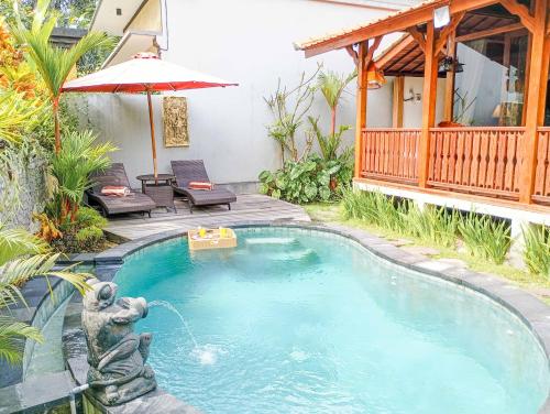 a swimming pool in the backyard of a house at Anggi Villas Ubud in Tegalalang