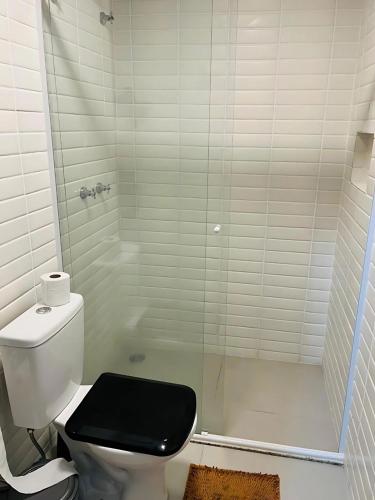 a bathroom with a toilet with a glass shower at Loft-Expo Norte-Brás-Anhembi in São Paulo