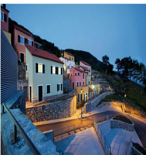 a view of a town at night with buildings at Nido Dei Gabbiani in Magliolo