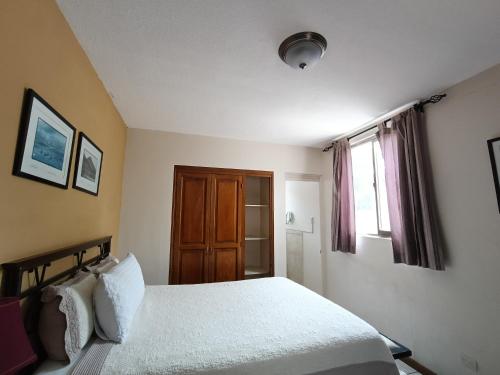 a bedroom with a bed and a window at Hotel Casa Blanca Inn in Estación Pamplona