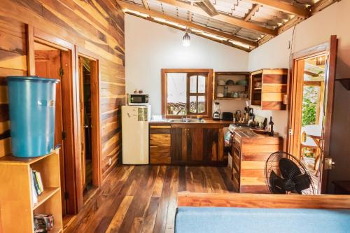a kitchen with wooden floors and a refrigerator at Wood Cabin - Cabana Maderas in Balgue