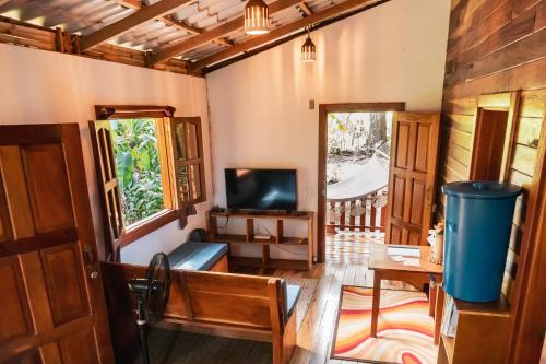 a living room with a tv and a window at Wood Cabin - Cabana Maderas in Balgue