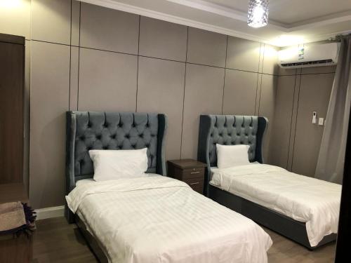 a room with two beds and a headboard at العنوان للشقق المخدومة ALanwaan of the units served in Dammam