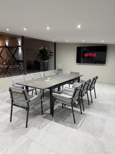 a table and chairs in a room with a tv at Palazzo Valentino in Naples