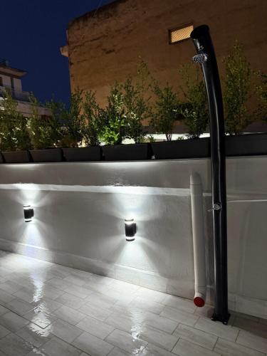 a white bench with lights on the side of a building at Palazzo Valentino in Naples