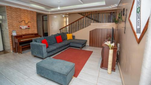 a living room with a couch and a piano at Syokiton Private Home near JKIA Airport in Syokimau