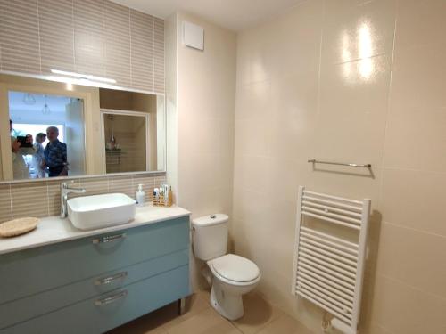 une salle de bain avec toilettes, lavabo et miroir dans l'établissement Appartement T2 proche plage avec terrasse, clim, Wi-Fi et parking - FR-1-781-102, à Valras-Plage