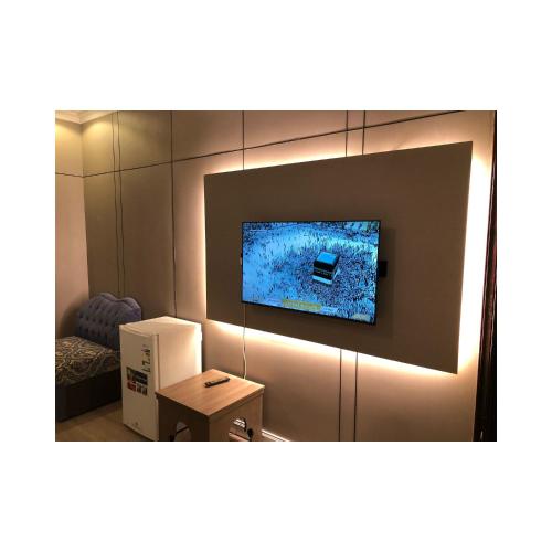 a room with a television on a wall at العنوان للشقق المخدومة ALanwaan of the units served in Dammam