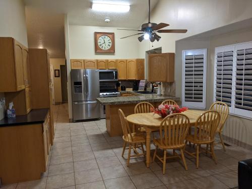 a kitchen with a table and chairs and a refrigerator at Beautiful Large Residential Home in Layton