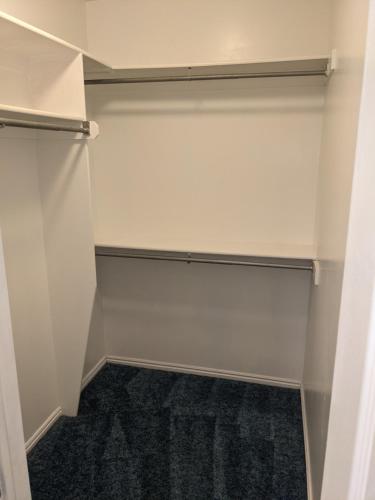 a walk in closet with white walls at Beautiful Large Residential Home in Layton