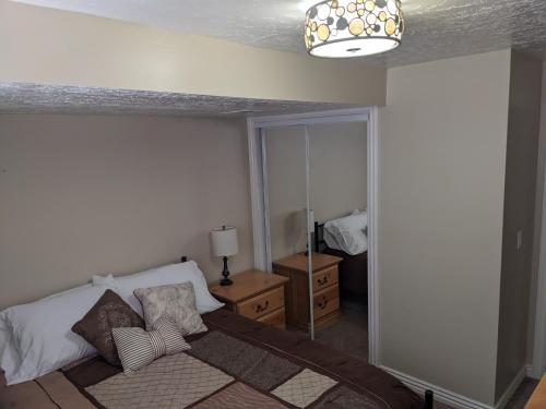 a bedroom with a bed and a mirror at Beautiful Large Residential Home in Layton