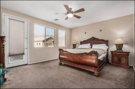 a bedroom with a bed and a ceiling fan at The Reserve Large Home and Pool in Phoenix