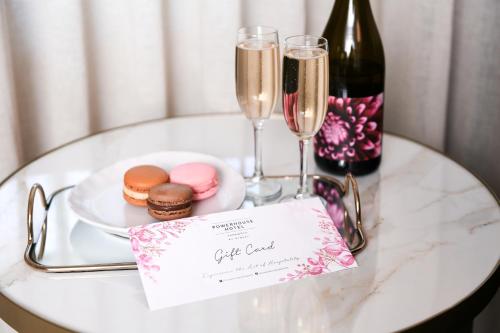 a table with a plate of food and champagne glasses at Powerhouse Hotel Tamworth by Rydges in Tamworth
