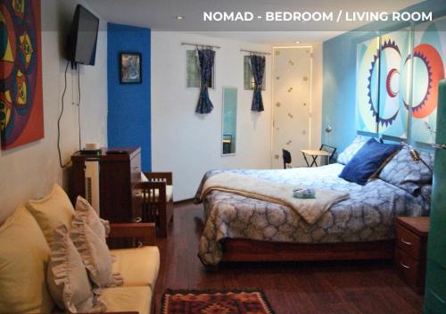 a bedroom with a bed and a living room at Casa Sentidos in Mexico City