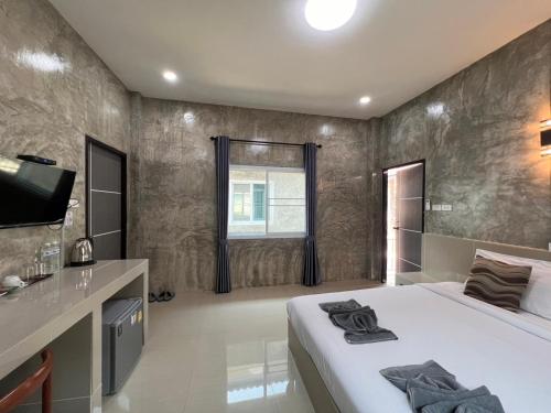 a bedroom with a bed and a sink and a television at Sor Boutique Resort Chiangrai in Chiang Rai
