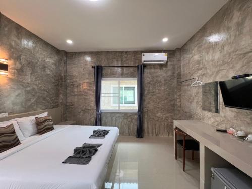 a bedroom with a large white bed and a sink at Sor Boutique Resort Chiangrai in Chiang Rai